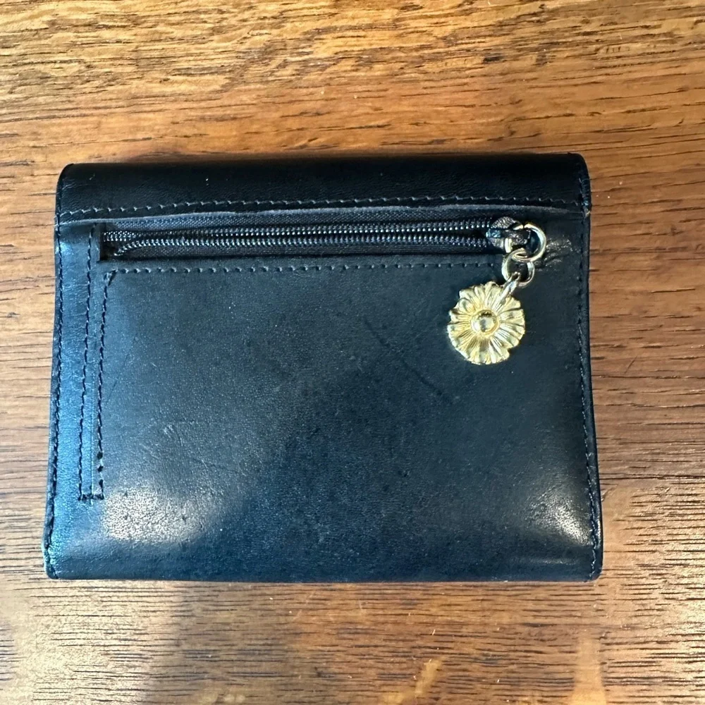 Black leather wallet with a red interior.